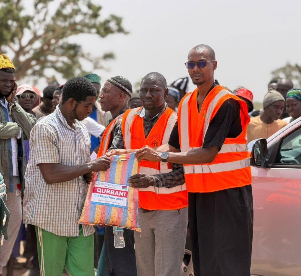 HMD Qurbani distribution team with an adult recipient