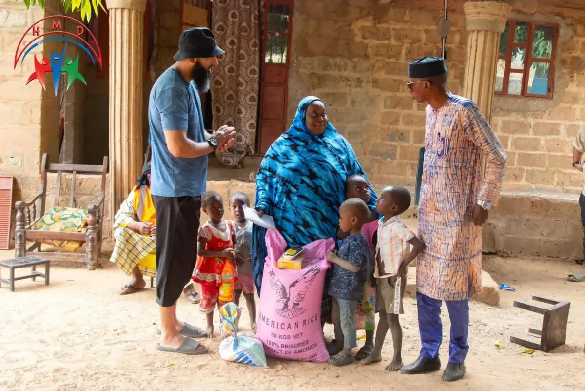 A mother and her children with a food pack delivered by HMD